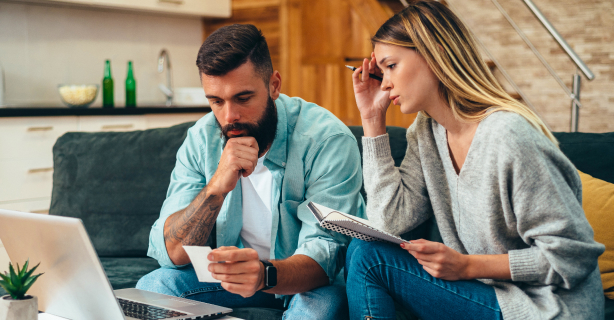 Overwhelmed couple on laptop working on their budget