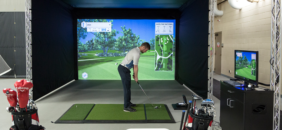 Golfer using the golf simulator in the Indoor Range