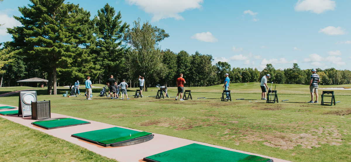 SentryWorld driving range with multiple golfers. 