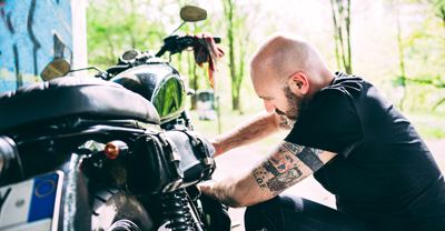 Man maintaining motorcycle