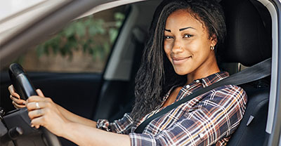 Young woman test driving a new car