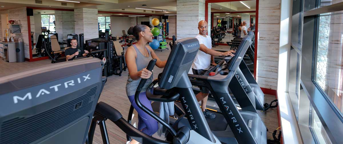 People using the cardio and weightlifting machines in the Fitness Center