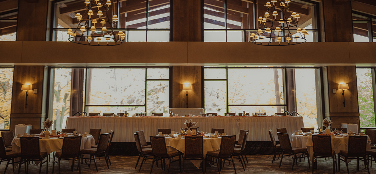 Head table and round tables set for reception at SentryWorld