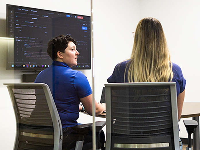 Information security associates meeting in a conference room.