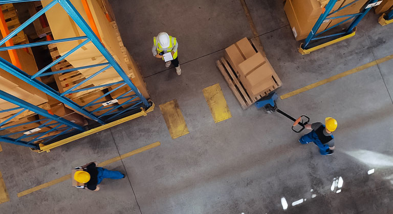 Aerial view people in hard hats working in factory