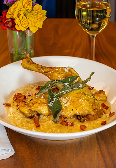 Bowl of Chicken Confit with white wine.
