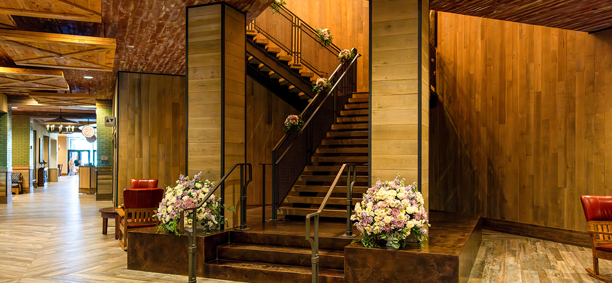carousel-wedding-venue-grand-hall-4-1200x556 Stairway that leads to the grand hall room decorated with floral arrangements.