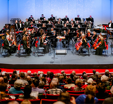 Orchestra on stage performing. 