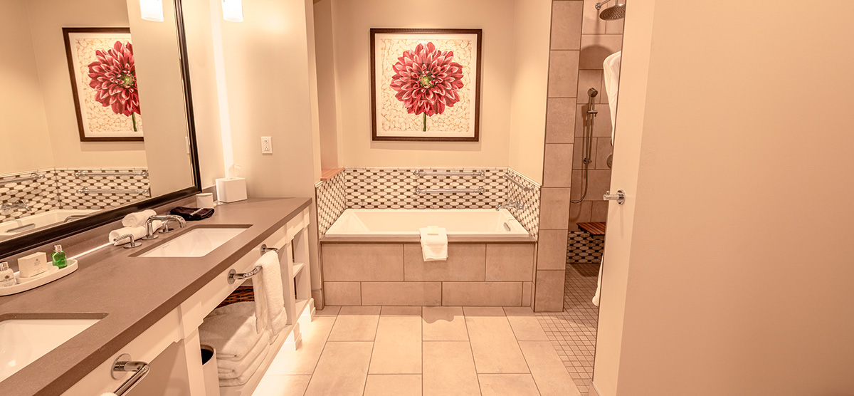 carousel-accessible-golf-view-executive-junior-suite-4-1200x556 Bathroom sinks and tub.
