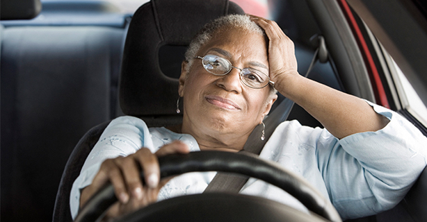 Senior woman in driver's seat of a car