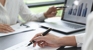 Two associates reviewing market performance.