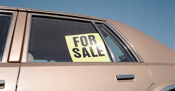 For Sale sign in the window of an older car