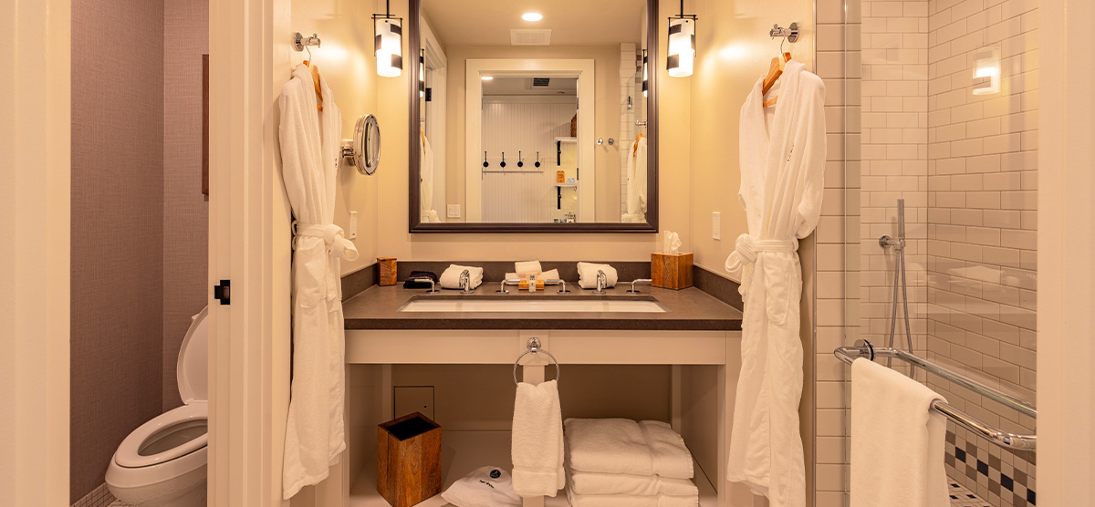 carousel-executive-king-suite-2br-7-1200x556 Bathroom with two bath robes.