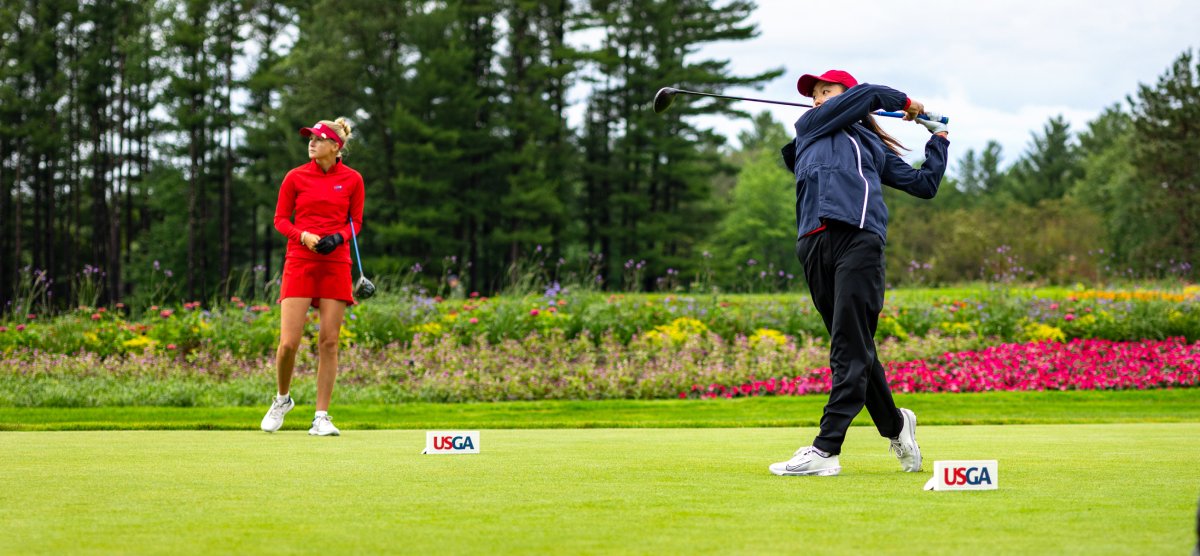 Two golfers teeing off at SentryWorld.
