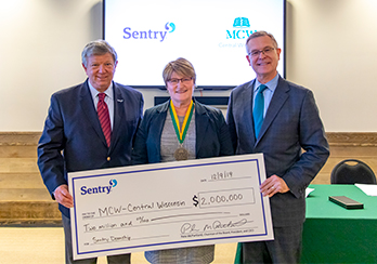 Pete McPartland CEO of Sentry handing over large check