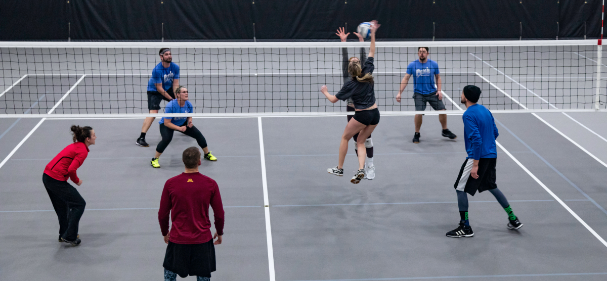 carousel-fall-league-signup-volleyball-3-1200x556 Players play volleyball at the SentryWorld fieldhouse.