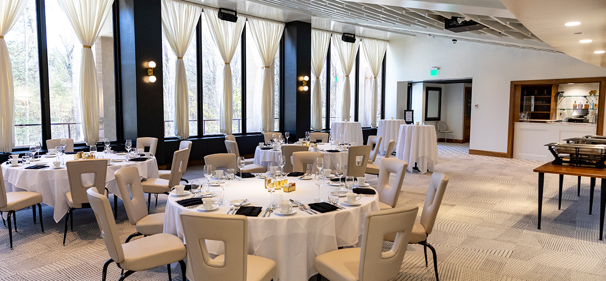 Tables set and large windows in the Muse Gallery Room