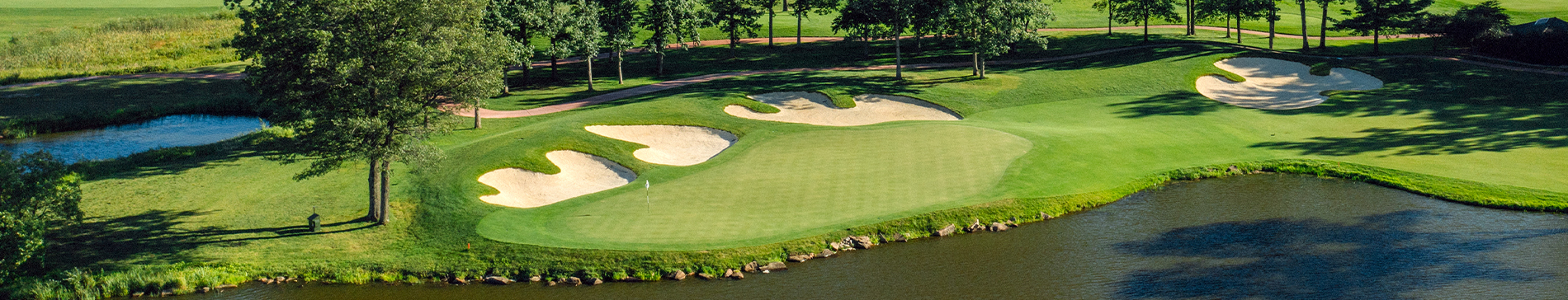 Aerial view of a green next to a water hazard at the SentryWorld golf course