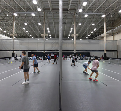 Games of pickleball being played in the SentryWorld field house.