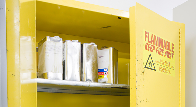 Yellow safety cabinet with chemicals