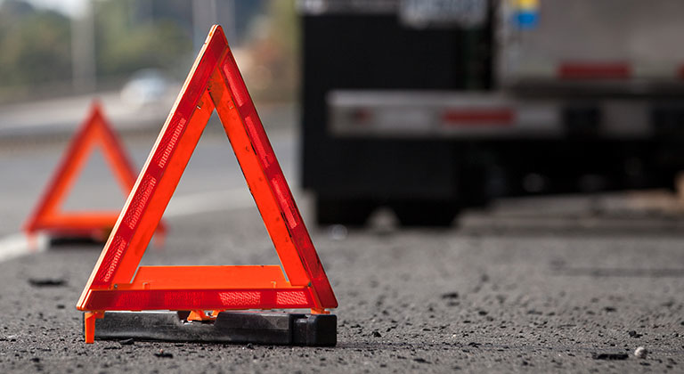 Two safety cones on road at accident scene