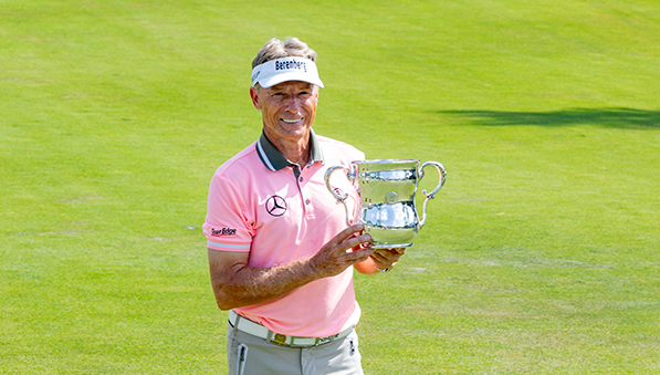 Bernhard Langer posing with the U.S. Senior Open trophy