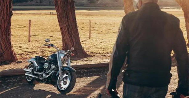 Person walking to a parked motorcycle