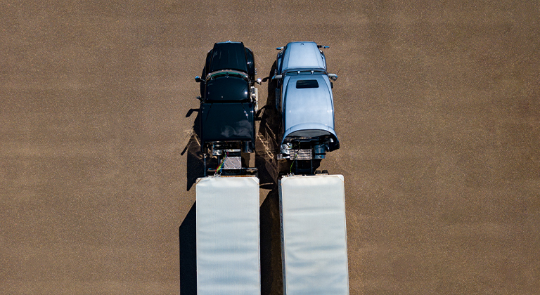 Two semi-trucks parked next to each other