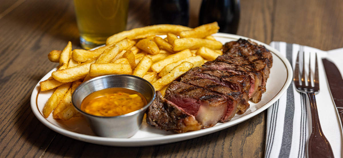 12-ounce Seared New York Strip and fries from the menu, plated at PJ's - SentryWorld