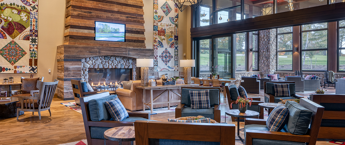 Couches and chairs around the TV and fireplace in The Inn's Living Room