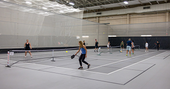 People playing pickleball in the SentryWorld fieldhouse