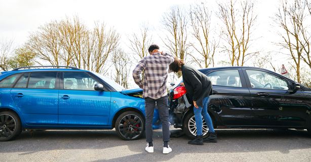 Two people talking after car accident