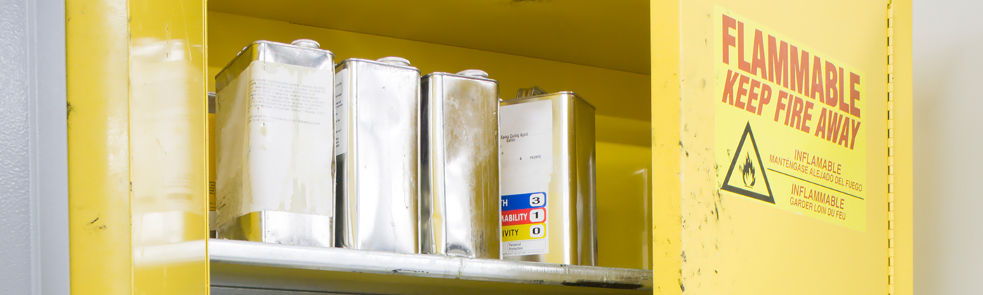 Yellow safety cabinet with chemicals