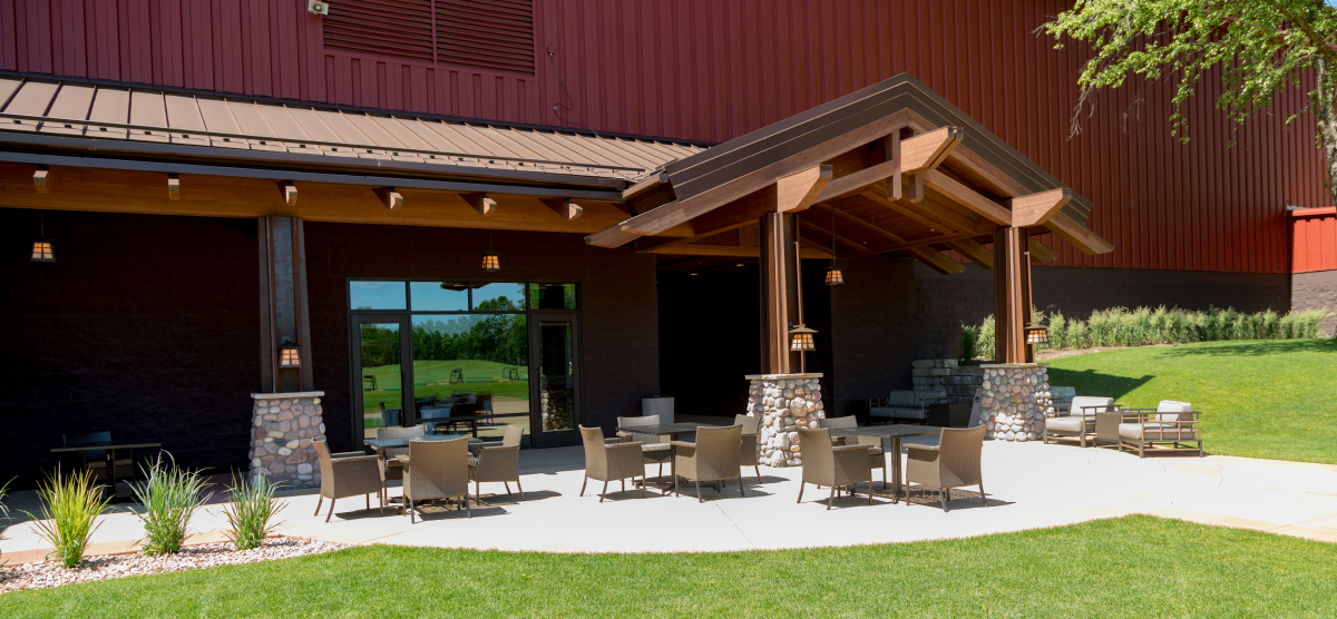 Outdoor patio area with multiple tables and chairs. 