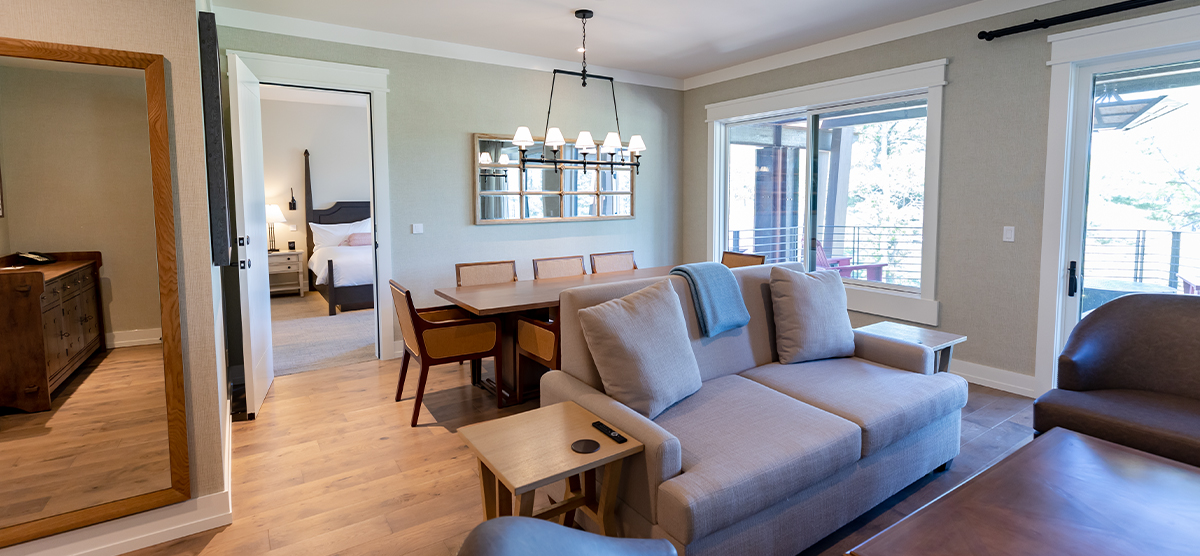 Couch and dining table in a Executive Level King Suite at The Inn