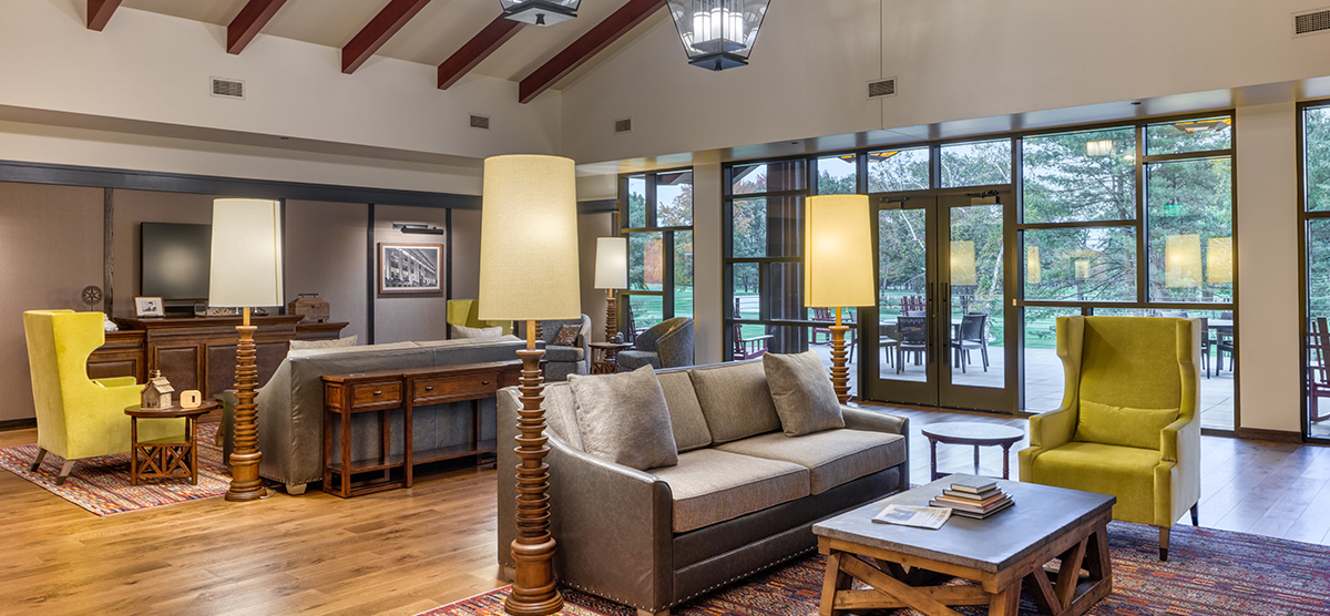 carousel-golf-view-executive-level-luxury-junior-suite-7-1200x556 Executive level lounge with couches, chairs, and terrace.