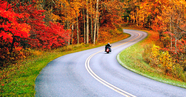 Motorcycle on a two-lane highway on an autumn day