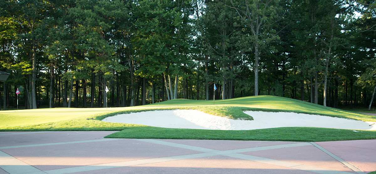 Sand trap alongside the practice chipping green at SentryWorld