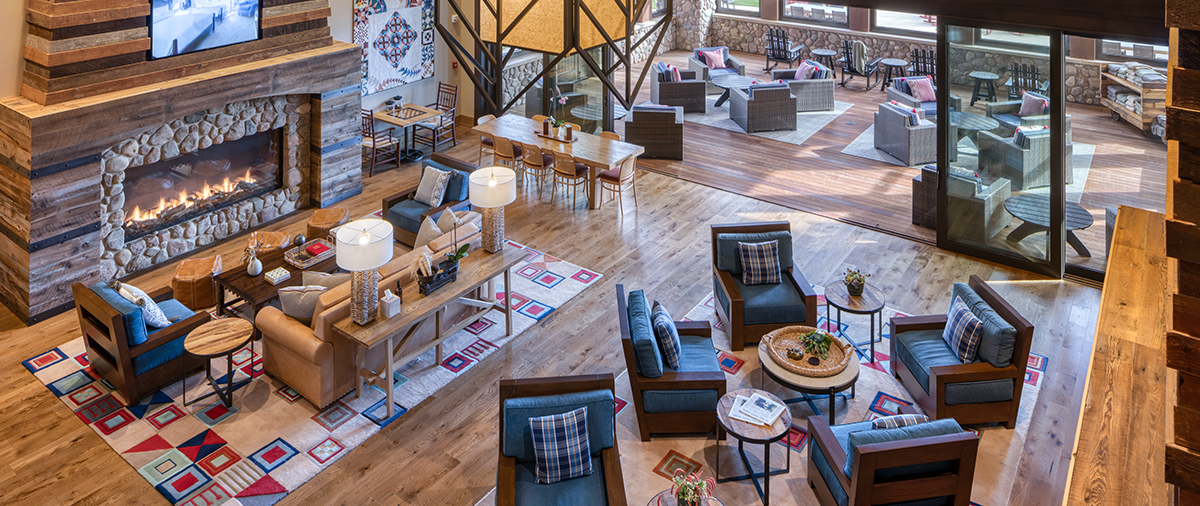 Aerial view of couch and chair seating around the fireplace in The Inn's Living Room