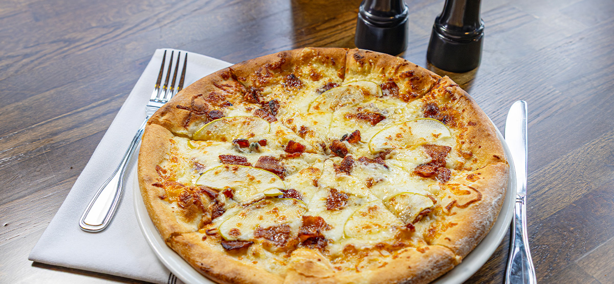 Sugar Shack with smoked maple syrup, apple butter, bacon, aged cheddar, and mozzarella.