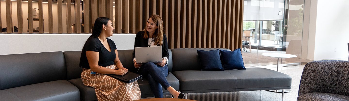 Two people talking in the Sentry corporate office lobby