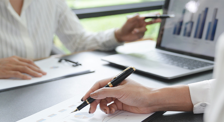 Two associates reviewing market performance.