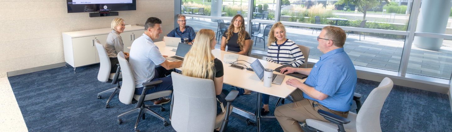 Group of associates working together at a conference table.