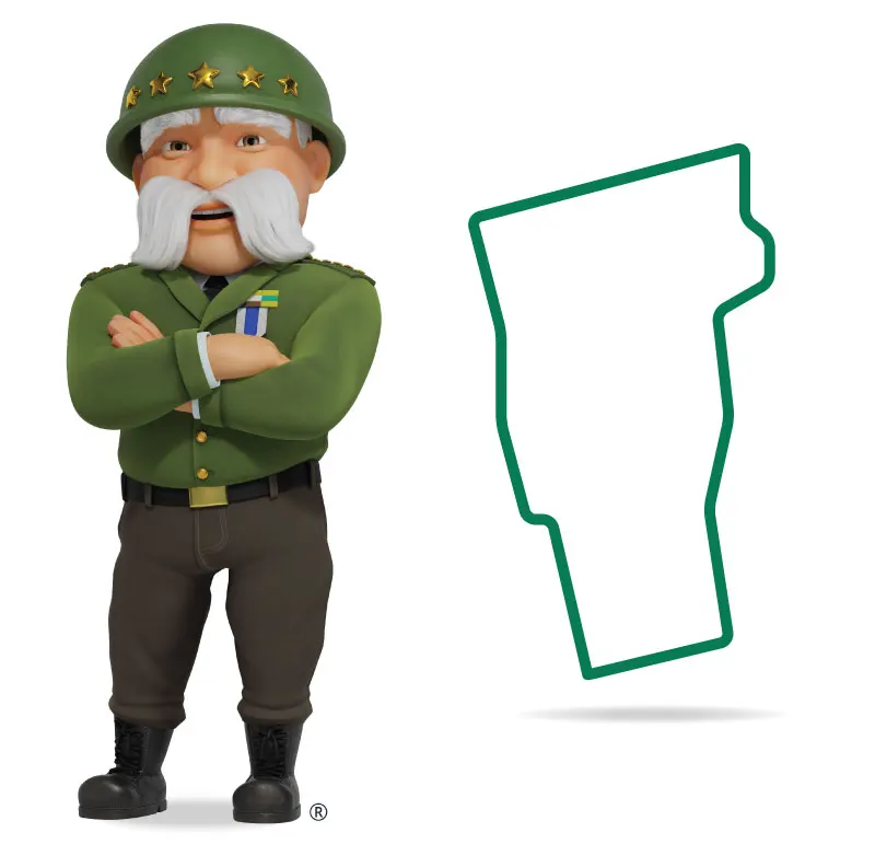 The General standing in front of Vermont with his arms crossed and a smile.
