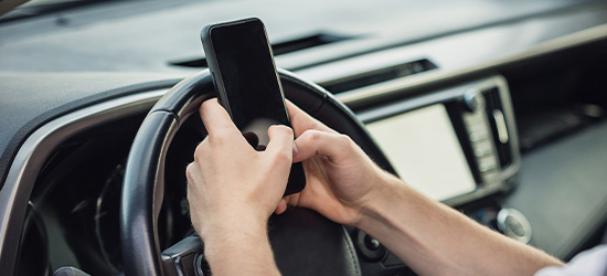 Driver distracted by cell phone in car