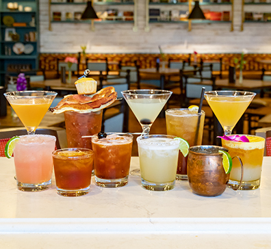 Cocktails lined up on the bar of the Library Café