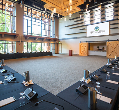 image-card-meet-sentryworld-396x364 Room with a large windows and u-shaped table with podium and screen.