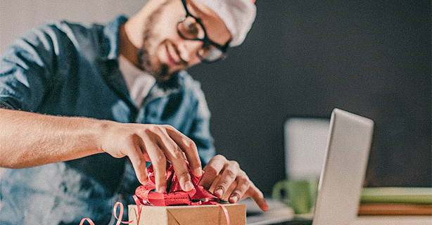 Man putting a bow on a gift