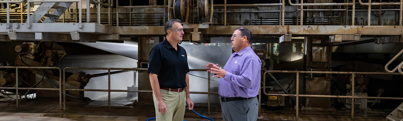 Two men talking in an industrial setting