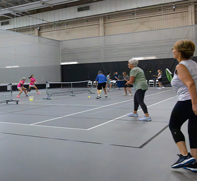 Games of pickleball being played in the SentryWorld field house.